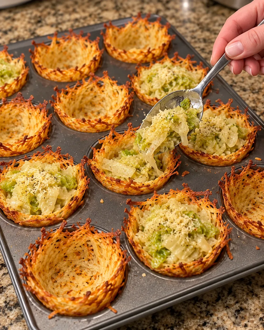 Spoon filling golden shredded potato shells with tender garlic Parmesan cabbage